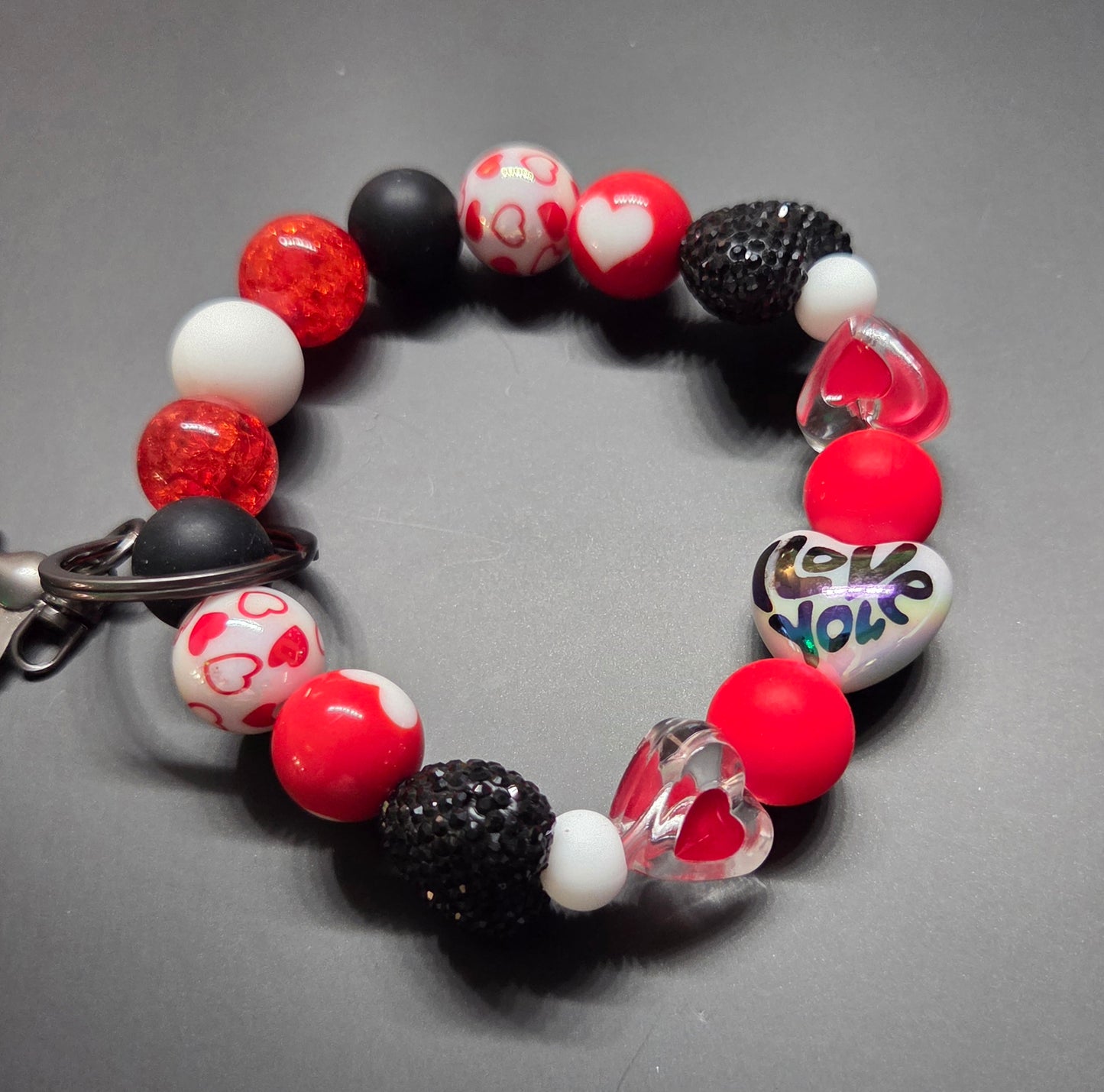 Valentine's Day - Wristlet - This one is very unique feat black, white, & Red Beads with Hearts and Rhinestones. If you like alt. Valentine's Day colors, this is for you! Black Hardware