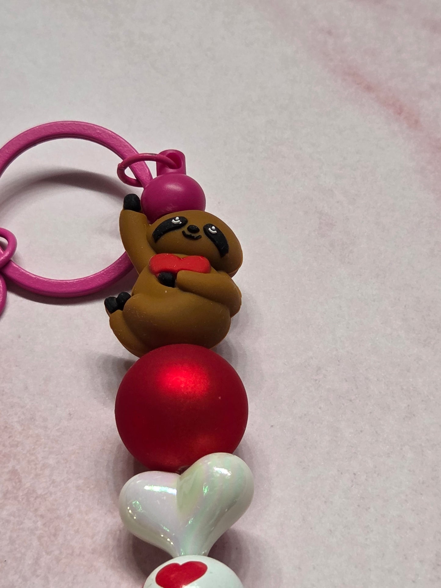 Valentine's Day - Keychain/Purse Charm - Sweet Sloth Holding Tight onto Heart, with Pink Hardware. This one has my heart! Sloths are so sweet 🦥
