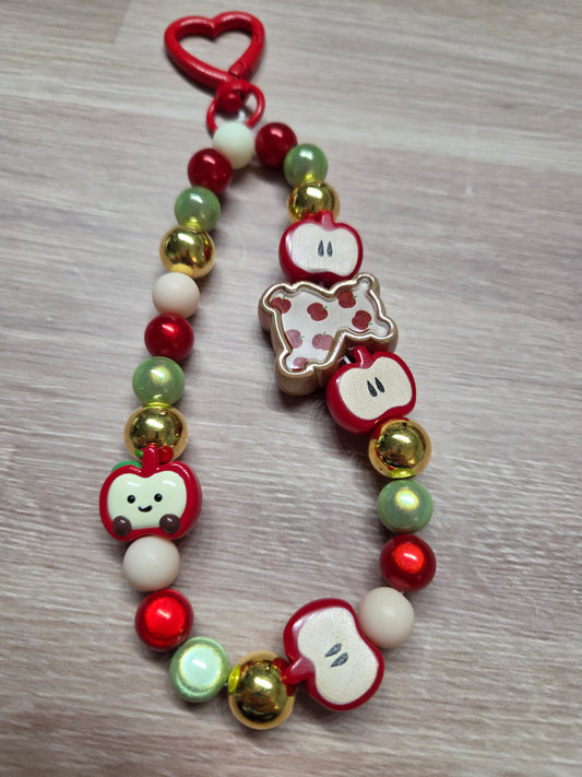 Phone Charm- Golden Bear covered with Apples on a Charm filled with Golds, Reds, Greens, and Crram colors, feat. a Little smiling Apple Who Fits Right in!