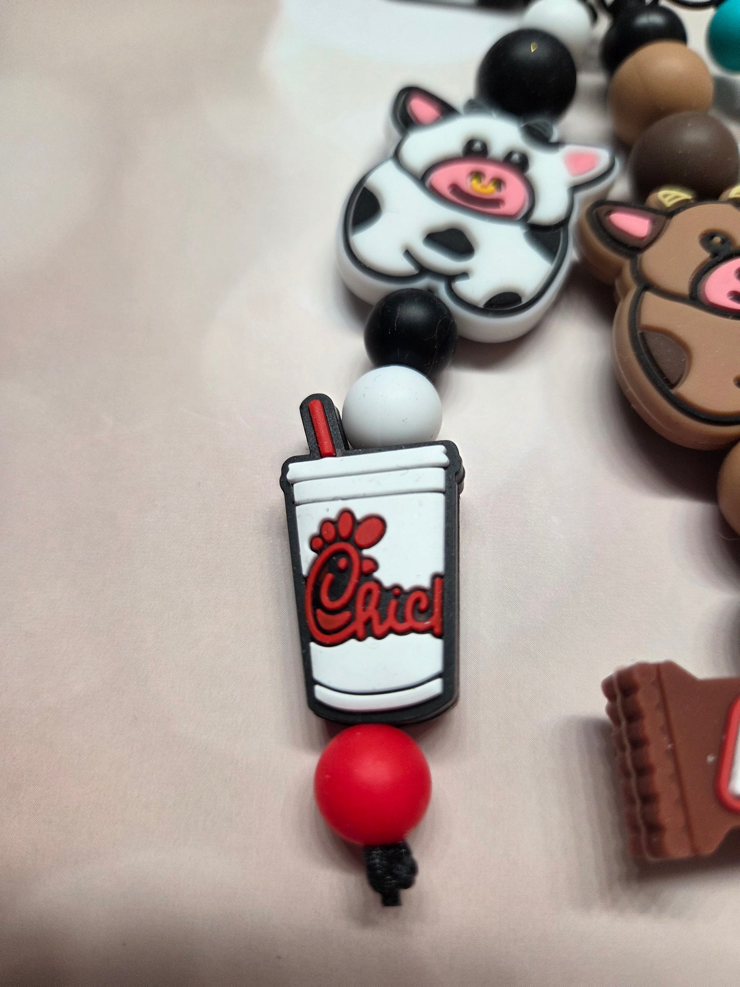 Cute Cow Keychain/Purse Charm. Each Cow has its own job! B&W-Eat Mor Chiken (works for that Chicken Restaurant)/Brownie-Chocolate Snickers Bar Maker/W&B- Milk Maker