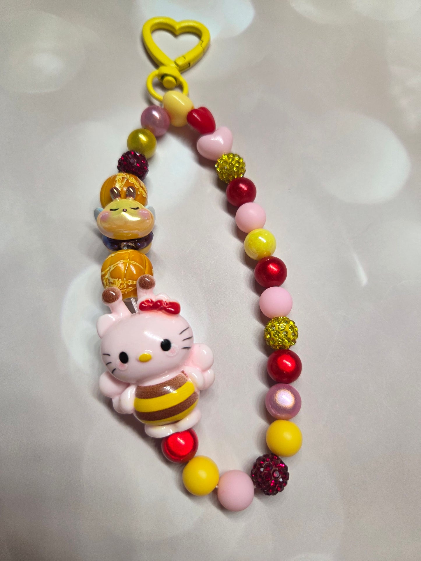 Phone Charm - HK in her adorable Bumblebee Costume while a little Bee follows her around with her honey beads!