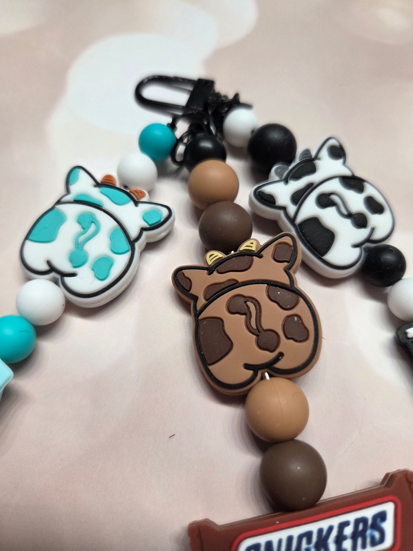 Cute Cow Keychain/Purse Charm. Each Cow has its own job! B&W-Eat Mor Chiken (works for that Chicken Restaurant)/Brownie-Chocolate Snickers Bar Maker/W&B- Milk Maker