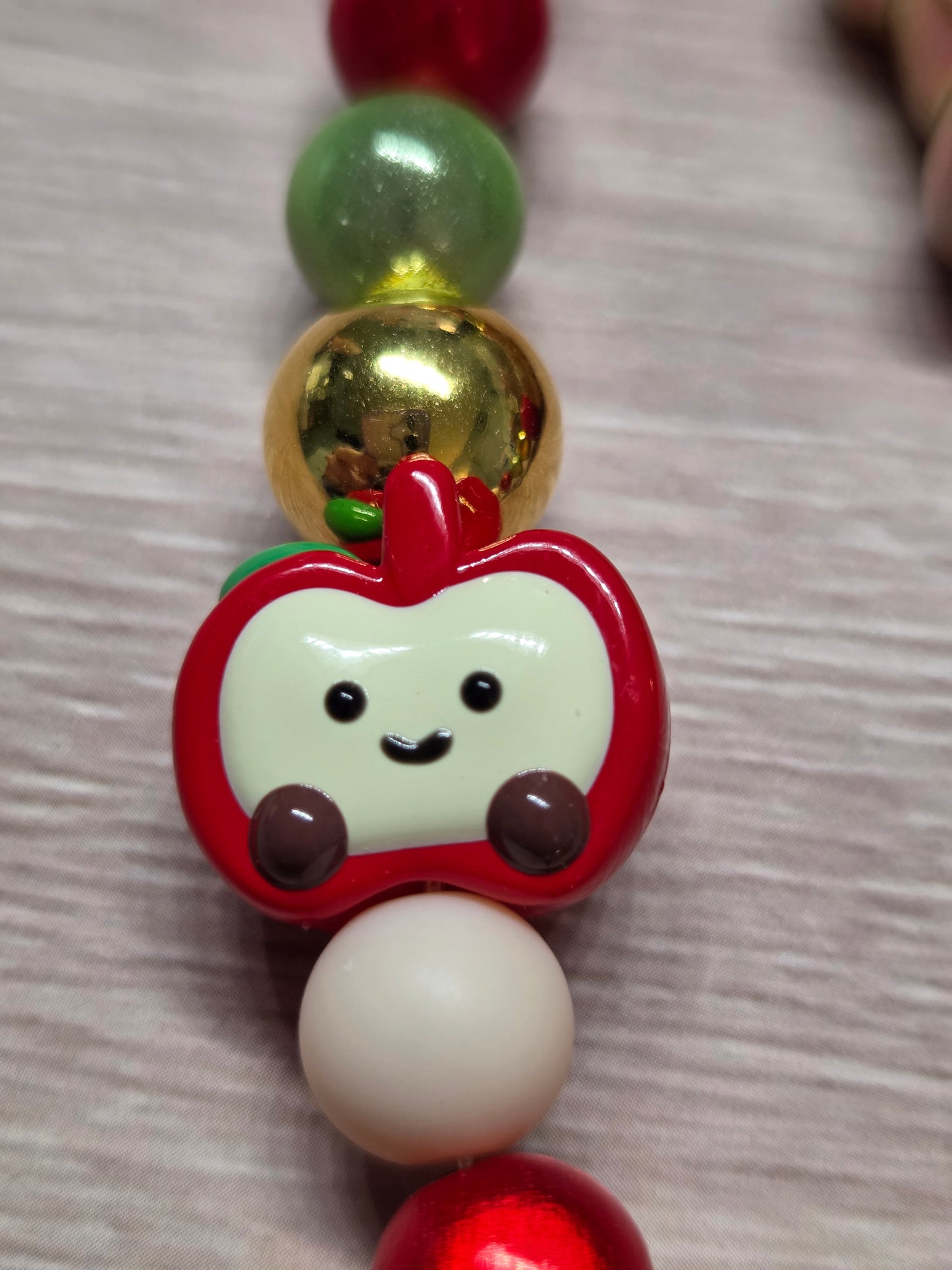 Phone Charm- Golden Bear covered with Apples on a Charm filled with Golds, Reds, Greens, and Crram colors, feat. a Little smiling Apple Who Fits Right in!