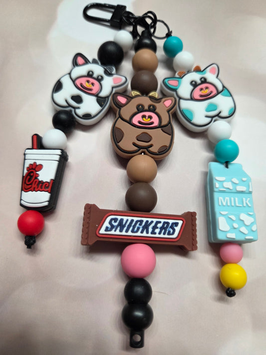 Cute Cow Keychain/Purse Charm. Each Cow has its own job! B&W-Eat Mor Chiken (works for that Chicken Restaurant)/Brownie-Chocolate Snickers Bar Maker/W&B- Milk Maker