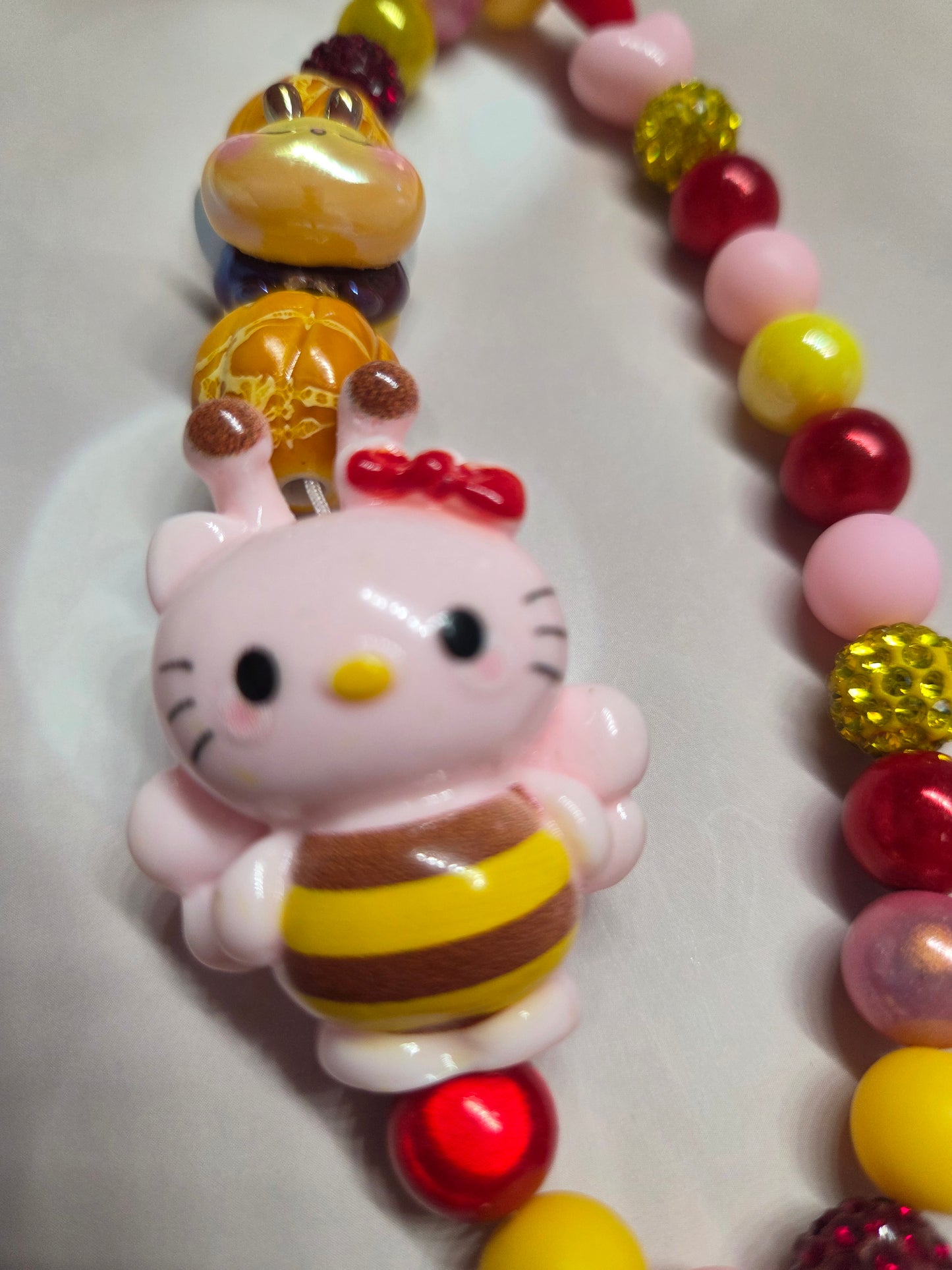 Phone Charm - HK in her adorable Bumblebee Costume while a little Bee follows her around with her honey beads!